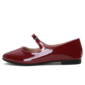 Red patent bow Mary Jane ballet flat side view on white