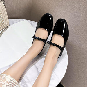 Black patent bow Mary Jane ballet flats worn