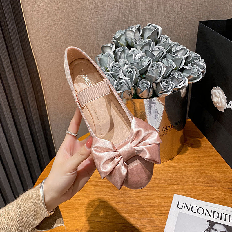 Pink oversized bow Mary Jane ballet flat held in hand