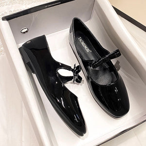 Black patent bow Mary Jane ballet flats in a box
