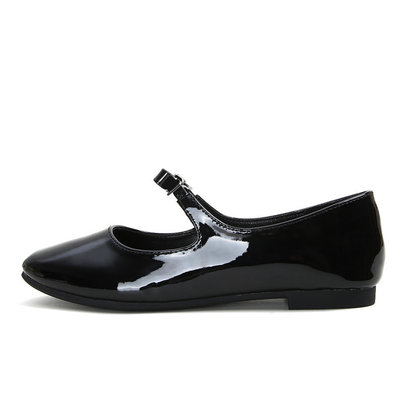 Black patent bow Mary Jane ballet flat side view on white
