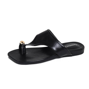 Black gold buckle toe-post sandal side view on white